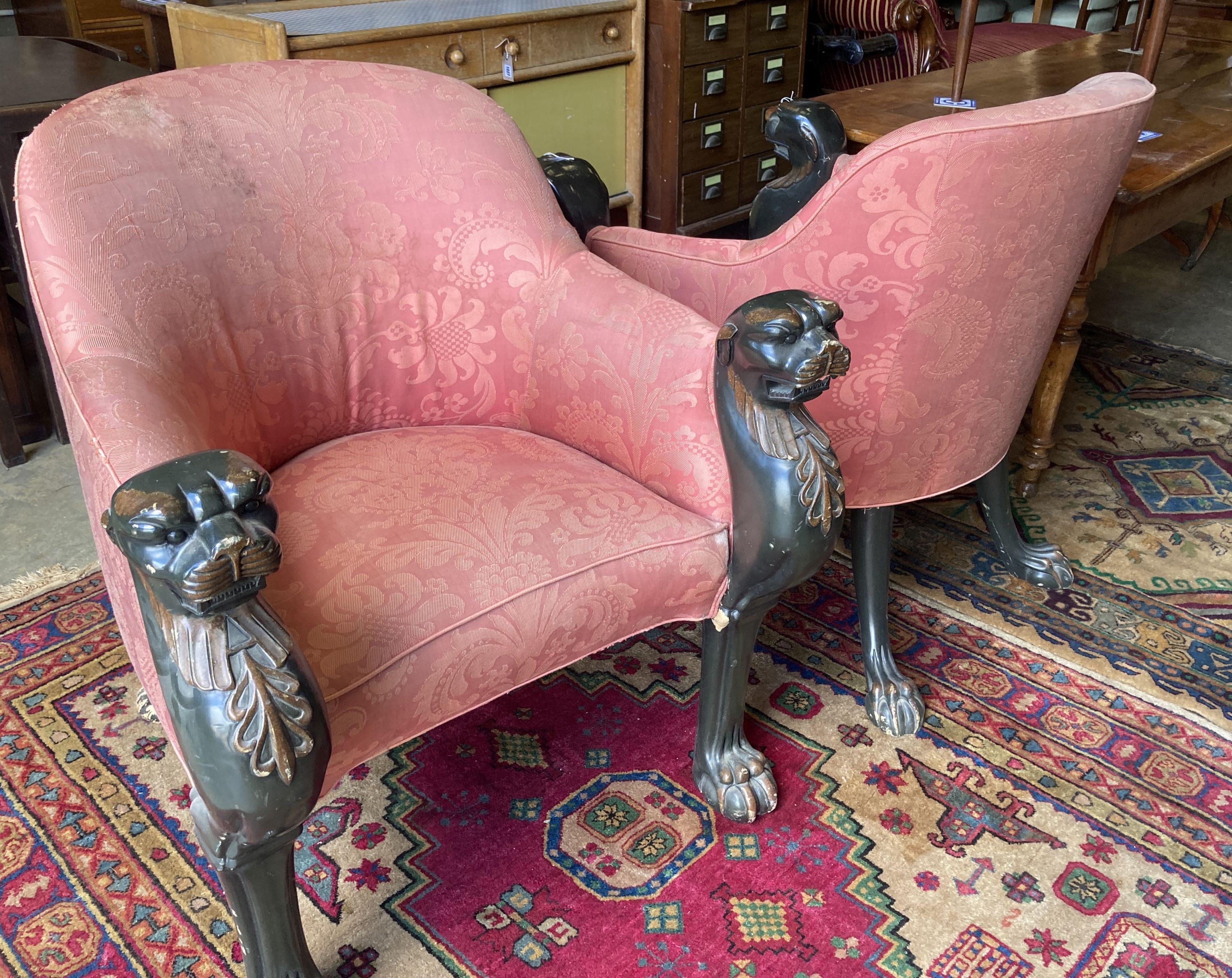 A pair of Empire style upholstered armchairs in the manner of Thomas Hope with leopards head terminals, width 80cm, depth 80cm, height